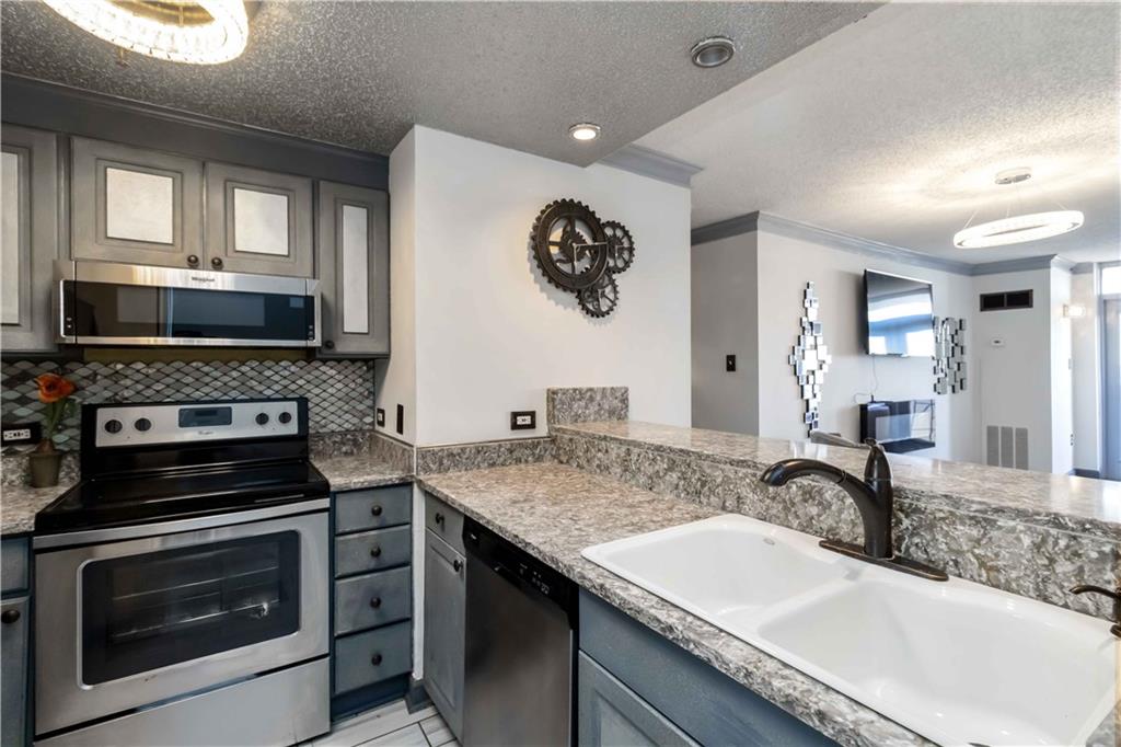 a kitchen with a sink stove and microwave