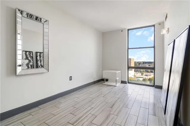 a area with wooden floor and a window