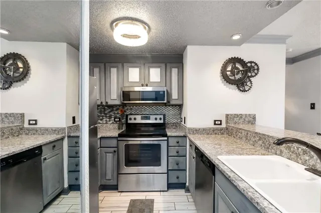 a kitchen with a sink stove and microwave