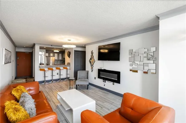 a living room with furniture fireplace and flat screen tv