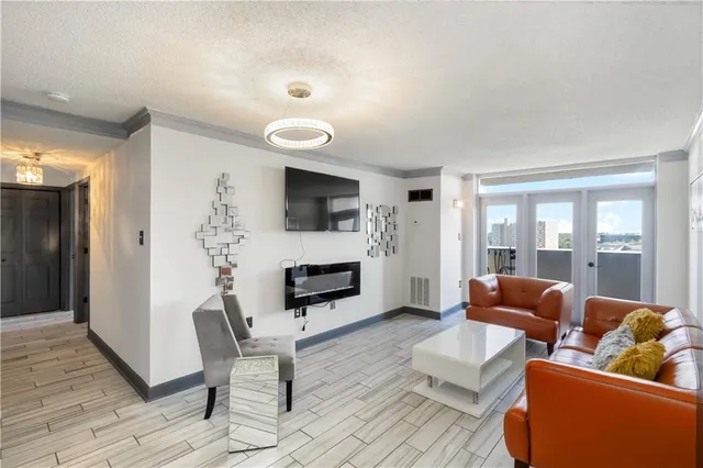 a living room with furniture flat screen tv and a fireplace