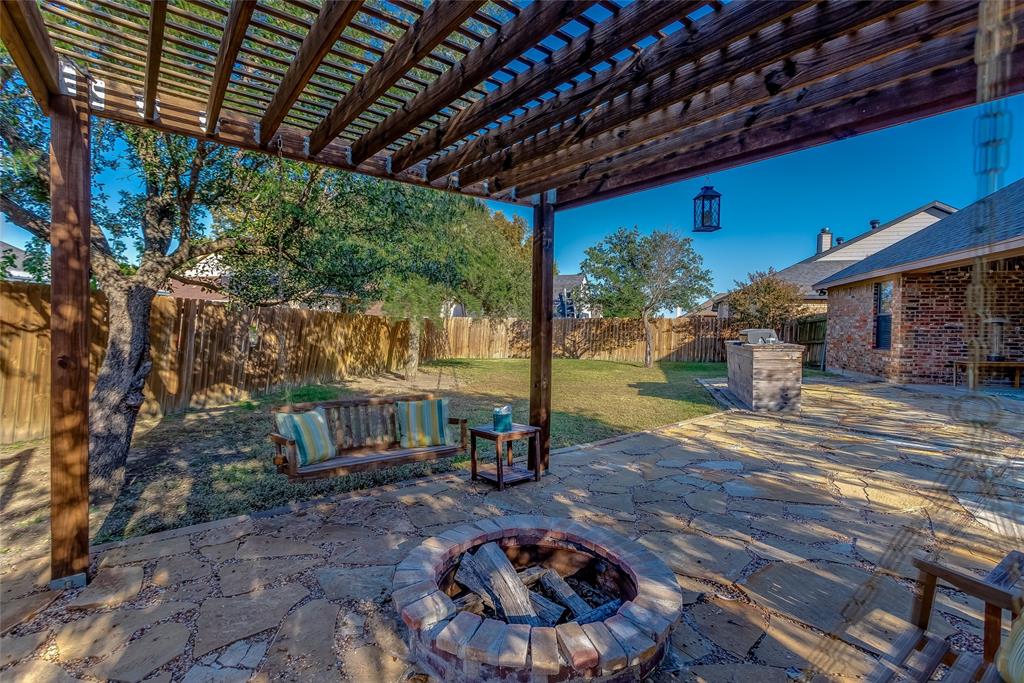 226 King George Road Ponder, TX 76259 - Photo 13 of 39 Fenced backyard with a pergola, a patio area, and an outdoor fire pit
