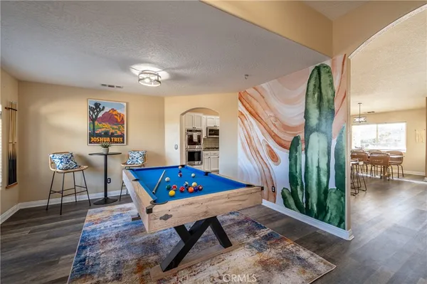 a living room with furniture pool table and a large window