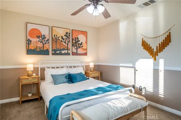 a bedroom with a bed and chandelier