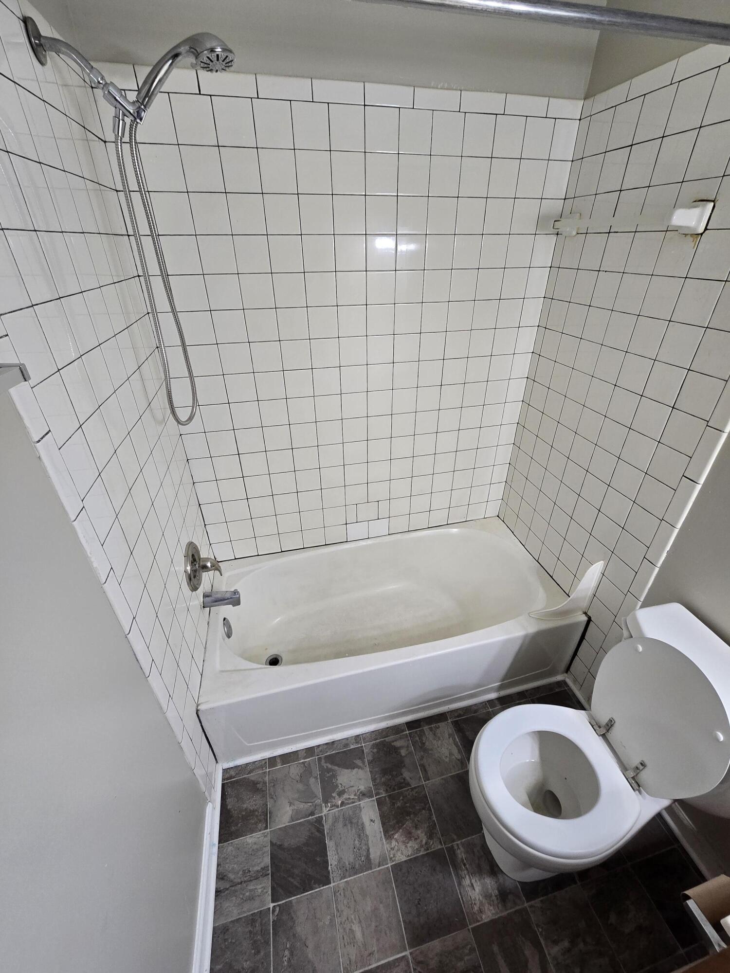 220 8th Street, Unit E10 Vinton, VA 24179 - Photo 7 of 13 a bathroom with a toilet and a bathtub