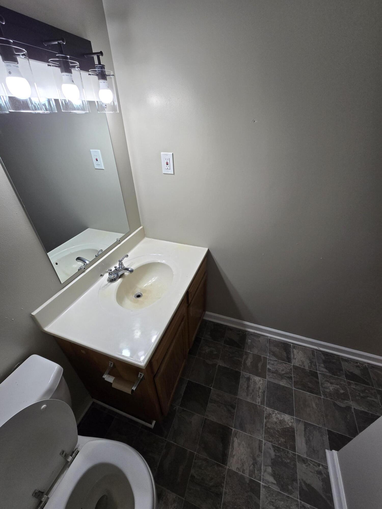 220 8th Street, Unit E10 Vinton, VA 24179 - Photo 8 of 13 a bathroom with a sink vanity and a mirror
