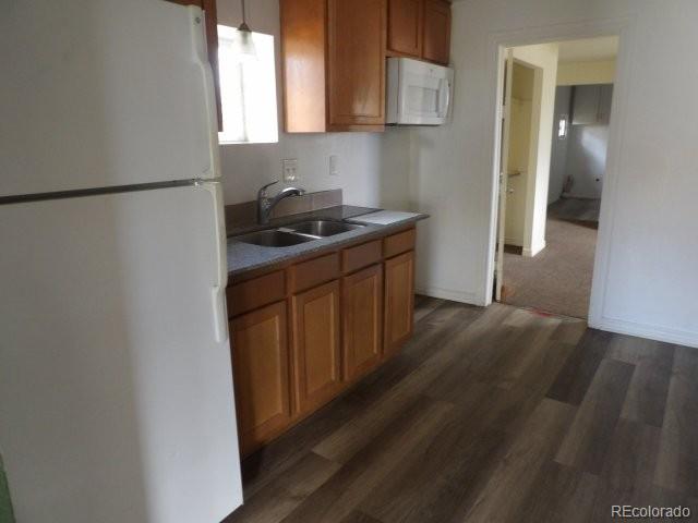 935 Walnut Street Brighton, CO 80601 - Photo 4 of 12 a kitchen with stainless steel appliances granite countertop a refrigerator a sink and a stove