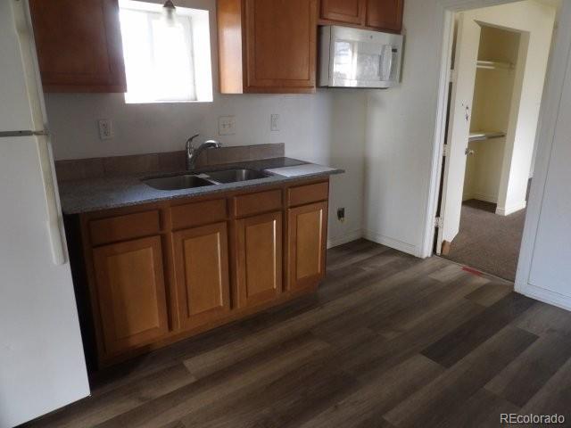 935 Walnut Street Brighton, CO 80601 - Photo 5 of 12 a kitchen with stainless steel appliances granite countertop wooden cabinets a refrigerator a sink and a stove