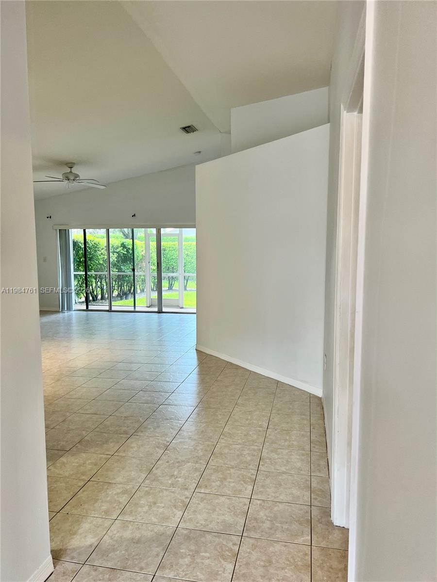 11854 Southwest 8th Street Pembroke Pines, FL 33025 - Photo 3 of 11 an empty room with large windows