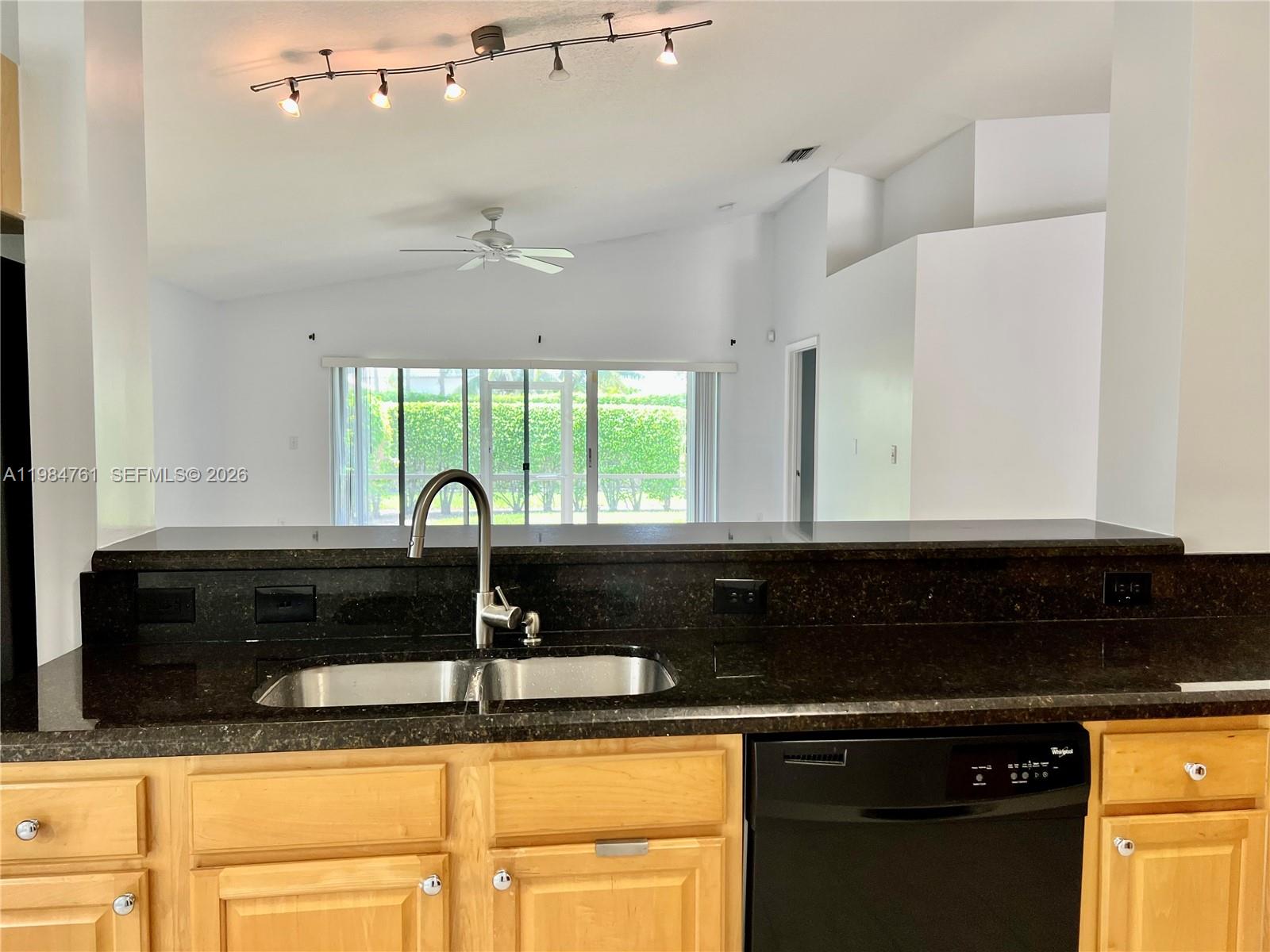 11854 Southwest 8th Street Pembroke Pines, FL 33025 - Photo 6 of 11 a kitchen with granite countertop a sink and a stove top oven