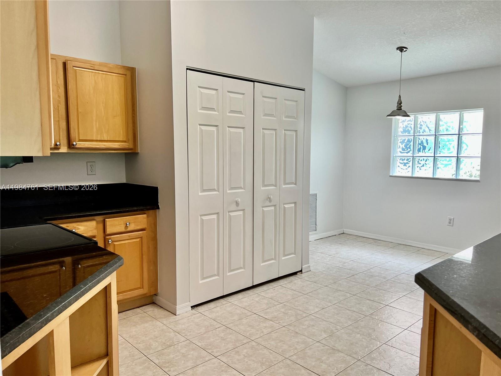 11854 Southwest 8th Street Pembroke Pines, FL 33025 - Photo 7 of 11 a view of a kitchen with a sink and dishwasher cabinet with wooden floor