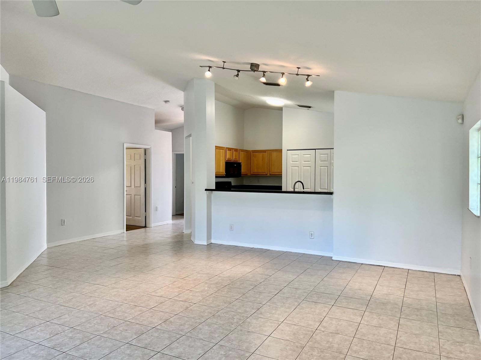 11854 Southwest 8th Street Pembroke Pines, FL 33025 - Photo 8 of 11 a view of a kitchen with an empty room