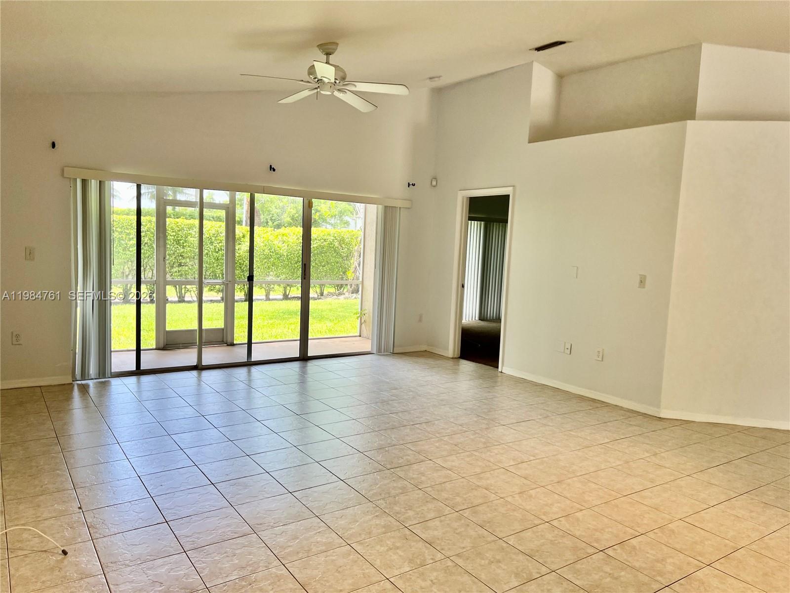 11854 Southwest 8th Street Pembroke Pines, FL 33025 - Photo 9 of 11 a view of an empty room with a window