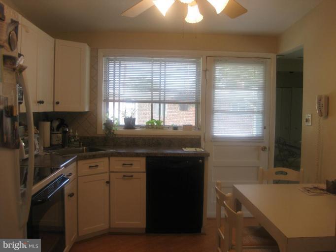 2418 Forest Green Road Baltimore, MD 21209 - Photo 6 of 12 a kitchen with a sink stove and cabinets