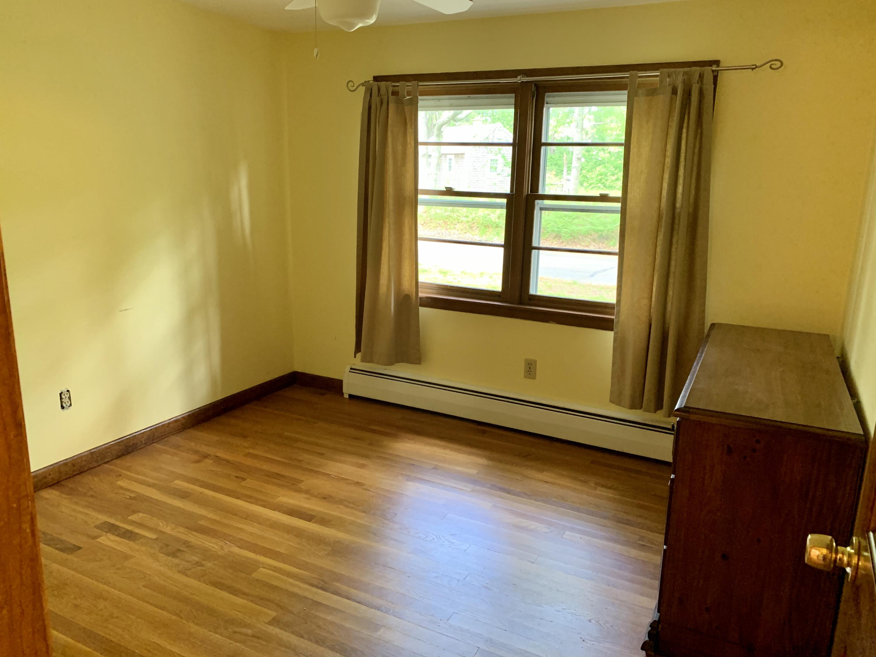 41 Suomi Road Hyannis, MA 02601 - Photo 9 of 25 an empty room with wooden floor and windows