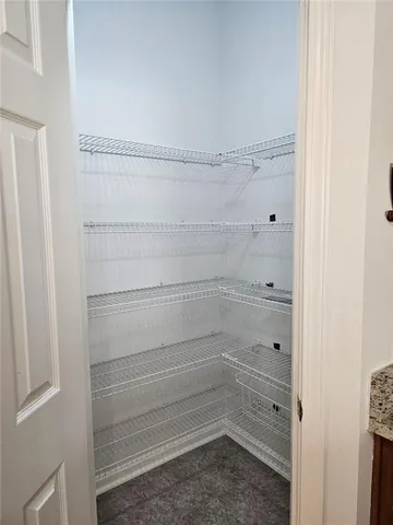 a view of a livingroom with a fireplace and window