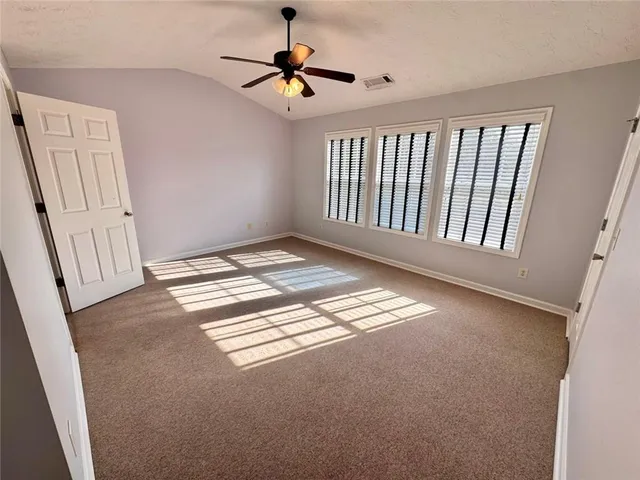 a view of room with a ceiling fan