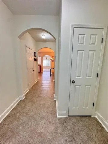 a view of a hallway with a black and white vase