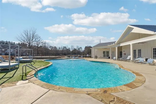a view of a house with swimming pool and sitting area