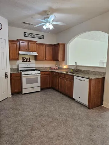 a kitchen with stainless steel appliances granite countertop a stove and a refrigerator