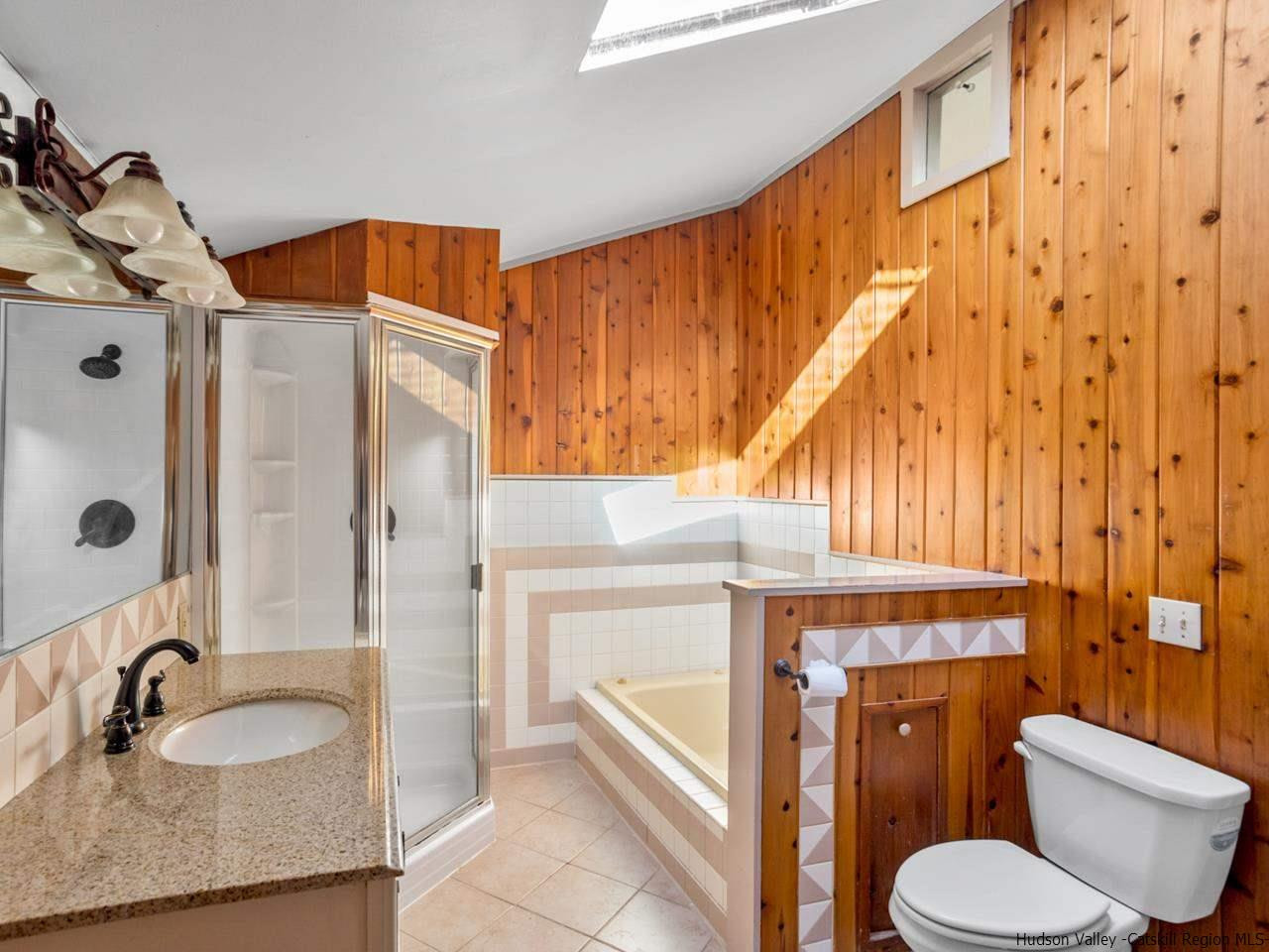 111 Spring Street Catskill, NY 12414 - Photo 14 of 28 a bathroom with a granite countertop sink and a mirror