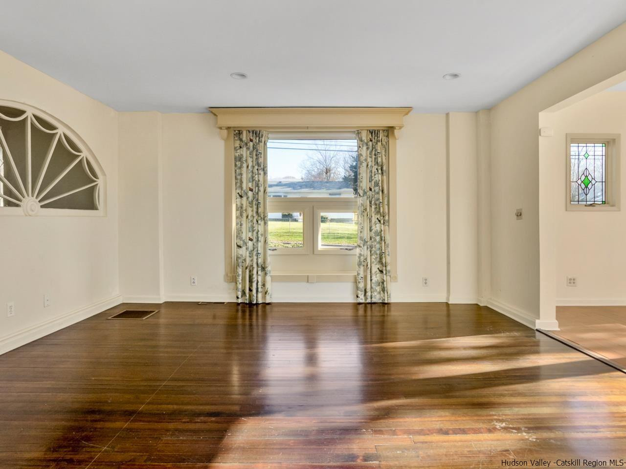 111 Spring Street Catskill, NY 12414 - Photo 17 of 28 a view of an empty room with window and wooden floor