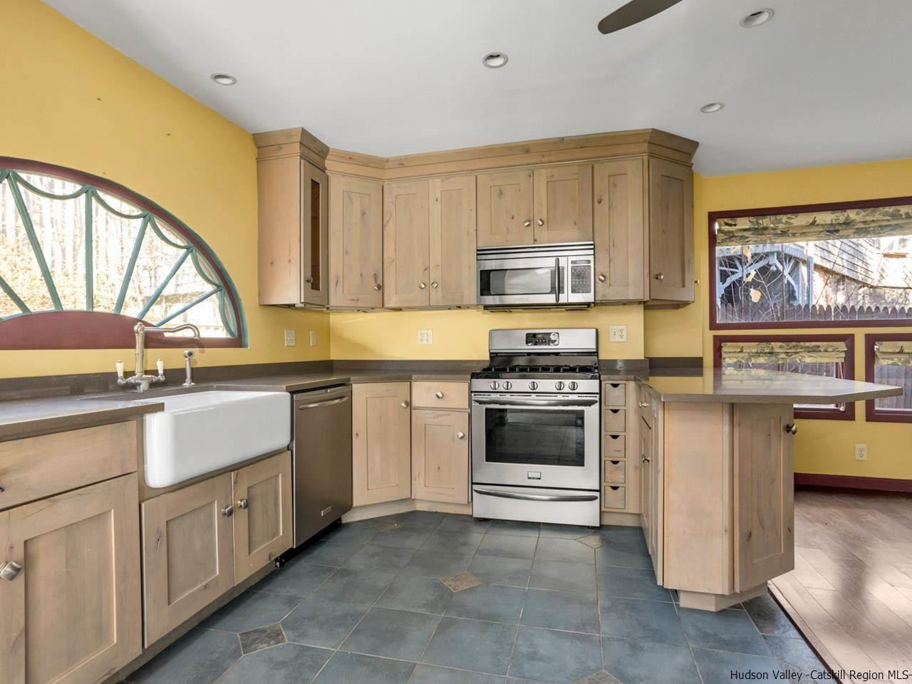 111 Spring Street Catskill, NY 12414 - Photo 7 of 28 a kitchen with stainless steel appliances granite countertop a stove a sink and a microwave