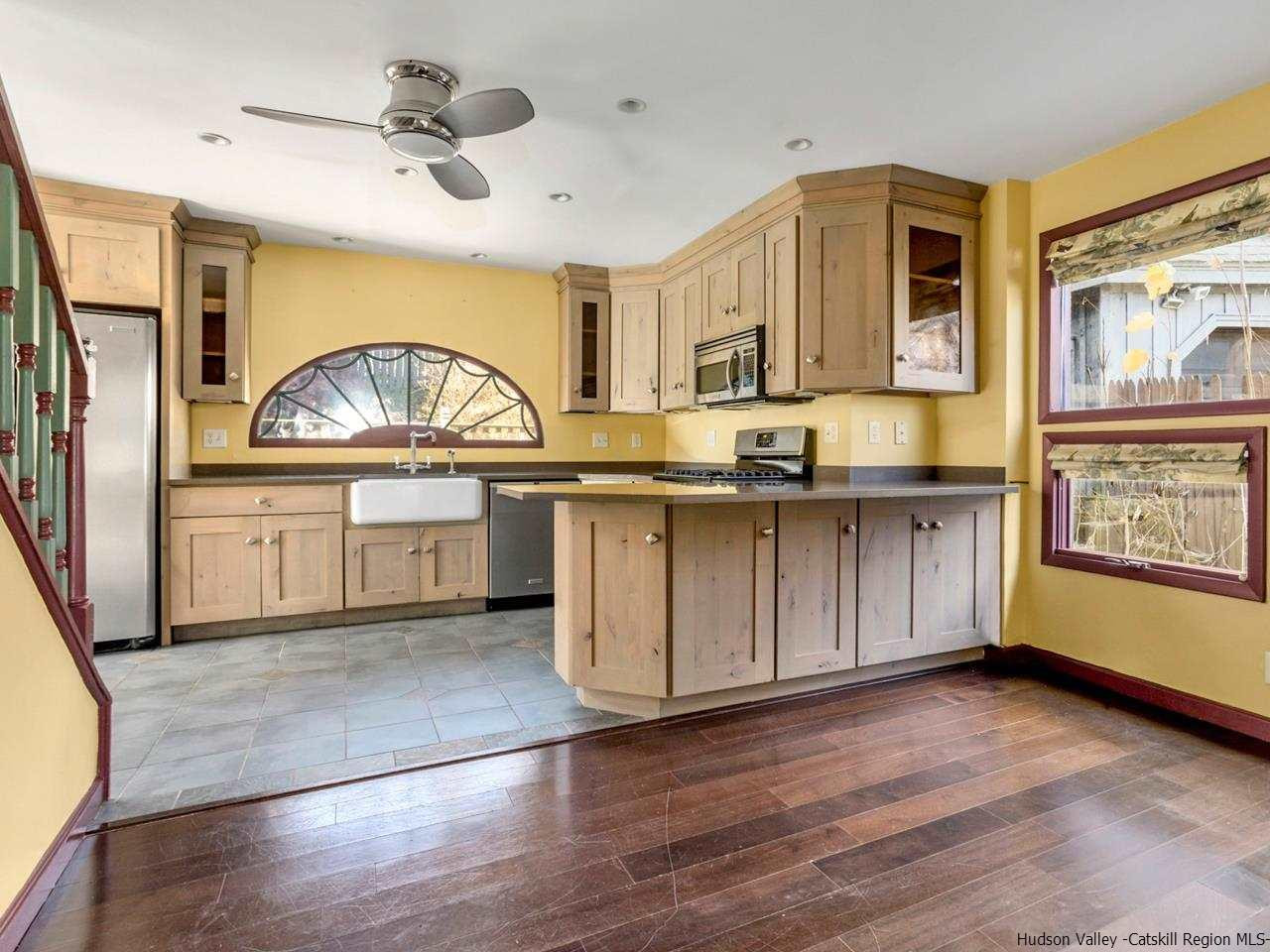 111 Spring Street Catskill, NY 12414 - Photo 8 of 28 a kitchen with stainless steel appliances granite countertop a sink and cabinets