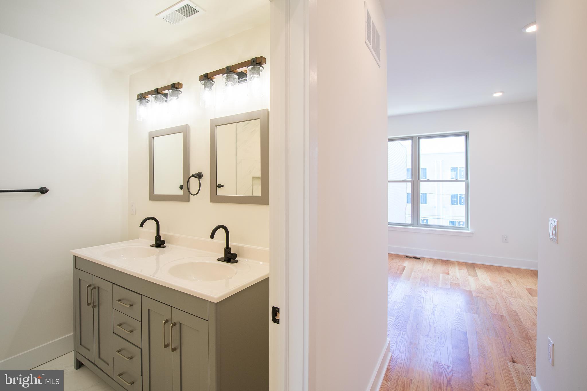 2022 North 5th Street, Unit 2 Philadelphia, PA 19122 - Photo 17 of 23 a bathroom with a sink and a mirror