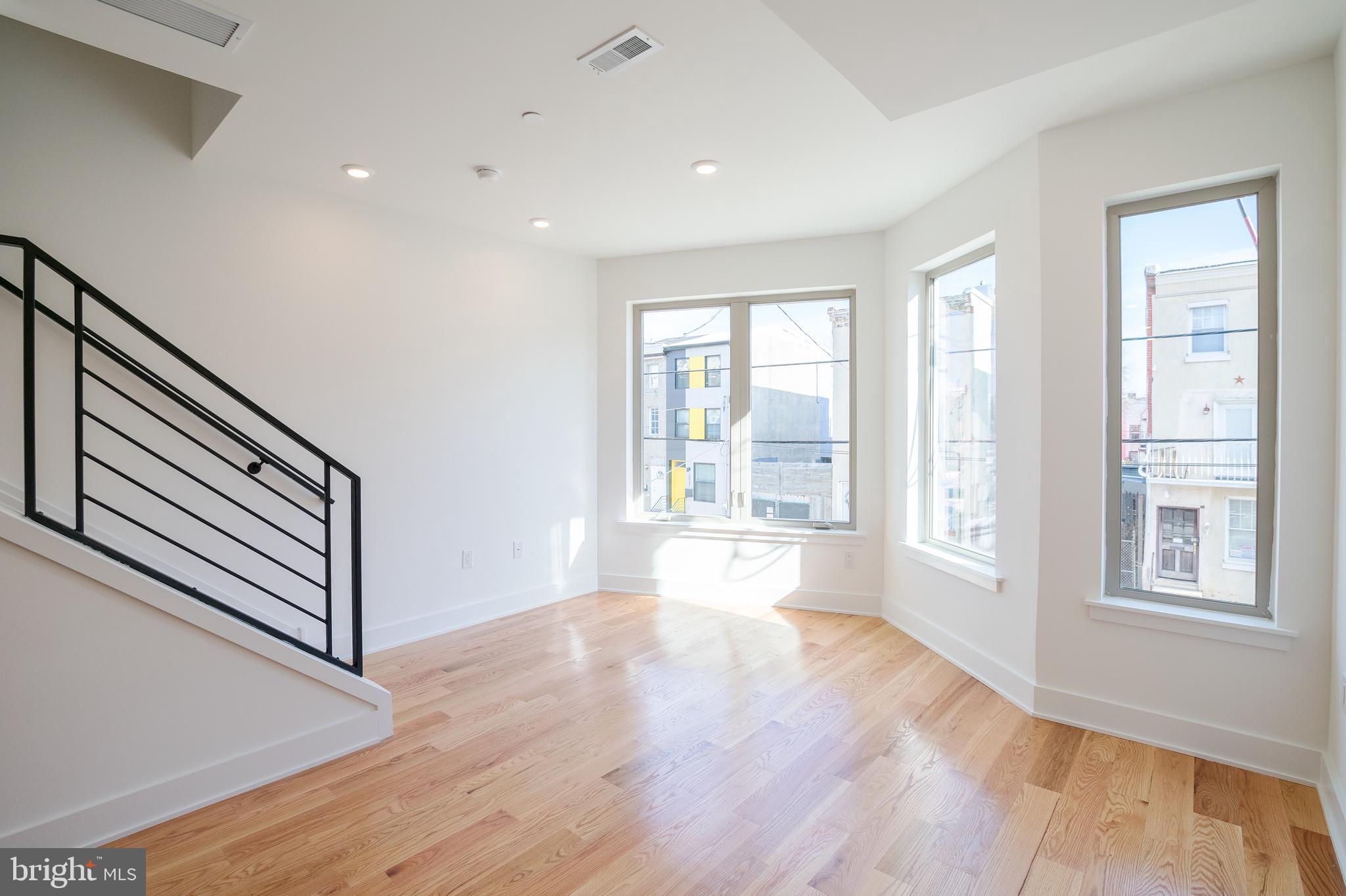 2022 North 5th Street, Unit 2 Philadelphia, PA 19122 - Photo 2 of 23 a view of an empty room with wooden floor and a window