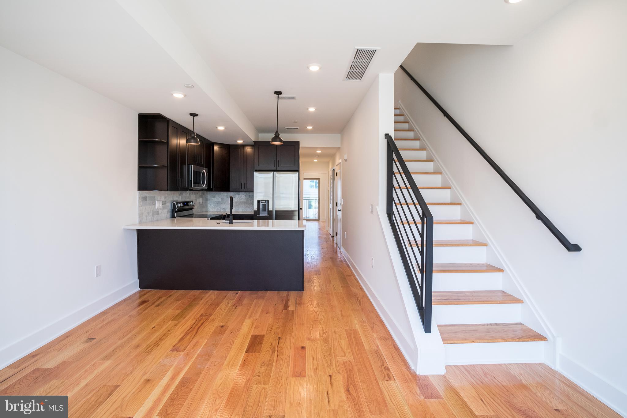 2022 North 5th Street, Unit 2 Philadelphia, PA 19122 - Photo 3 of 23 a view of kitchen with cabinets and wooden floor