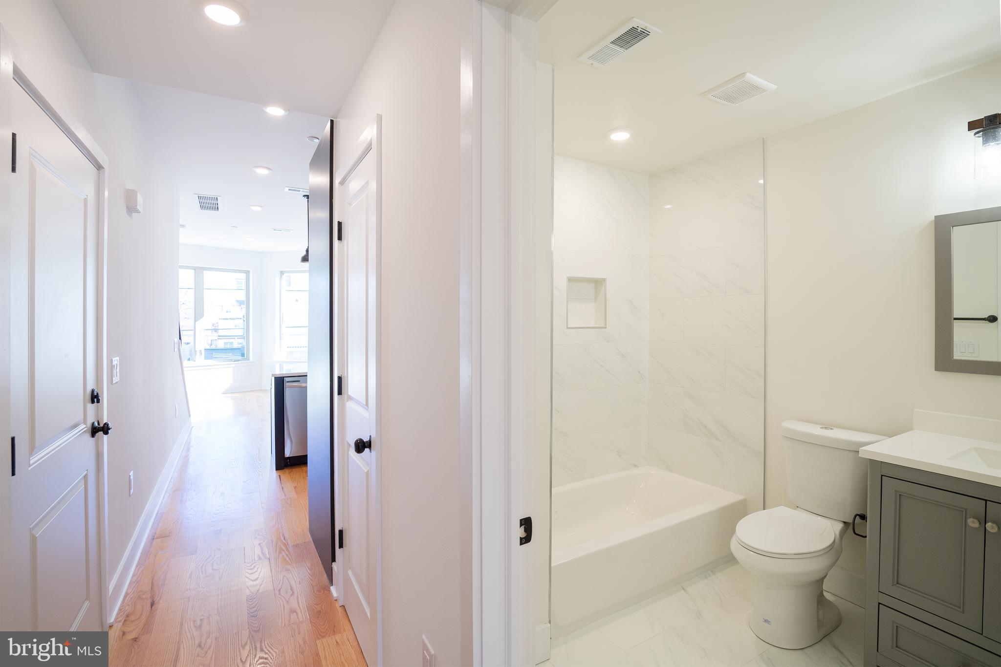 2022 North 5th Street, Unit 2 Philadelphia, PA 19122 - Photo 6 of 23 a bathroom with a shower a toilet and a glass door