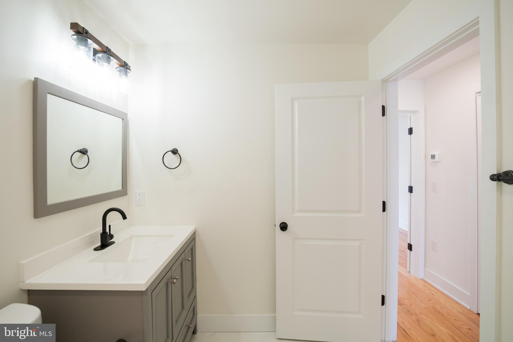 2022 North 5th Street, Unit 2 Philadelphia, PA 19122 - Photo 7 of 23 a bathroom with a sink and mirror