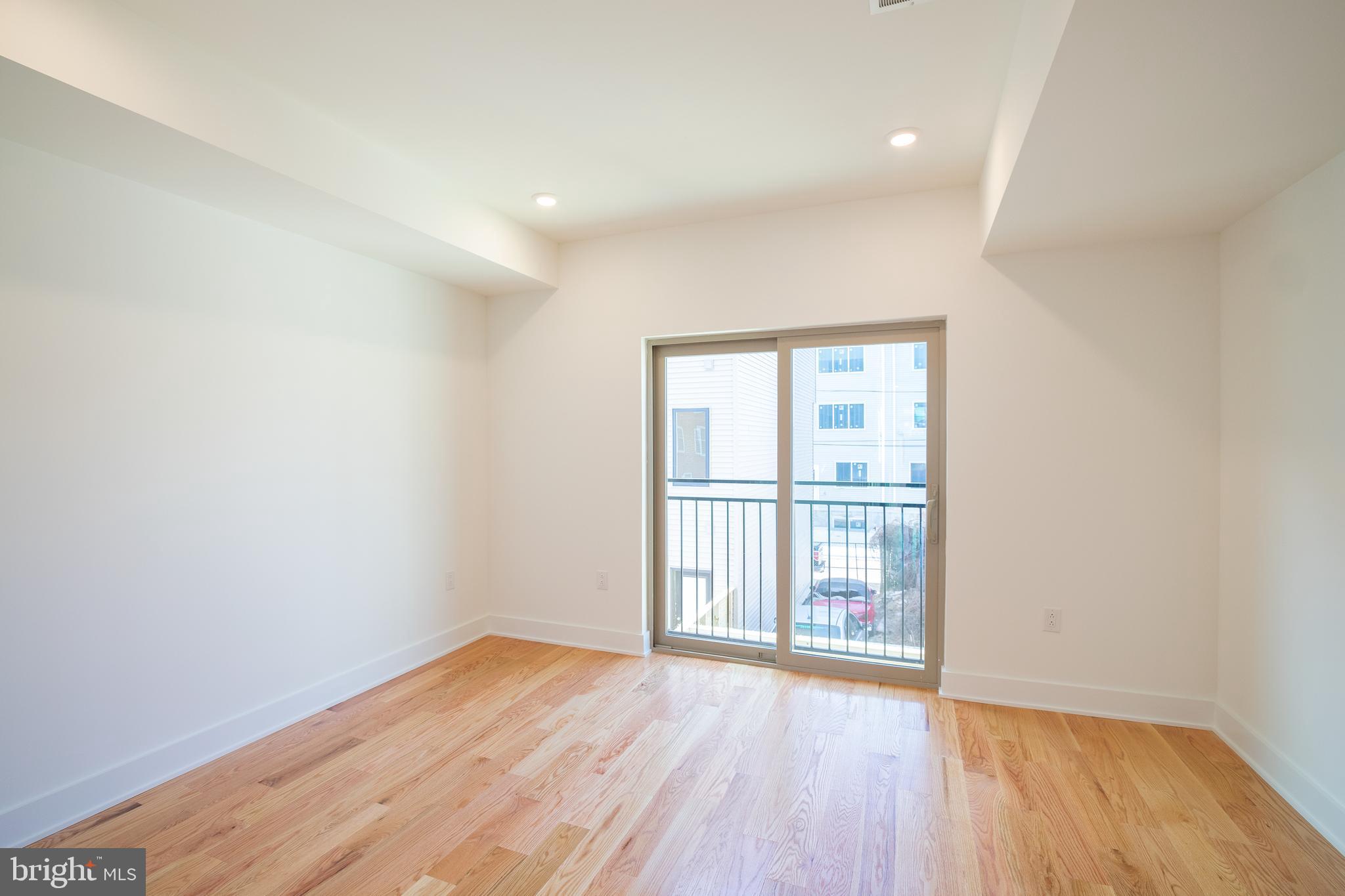 2022 North 5th Street, Unit 2 Philadelphia, PA 19122 - Photo 9 of 23 wooden floor in an empty room with a window