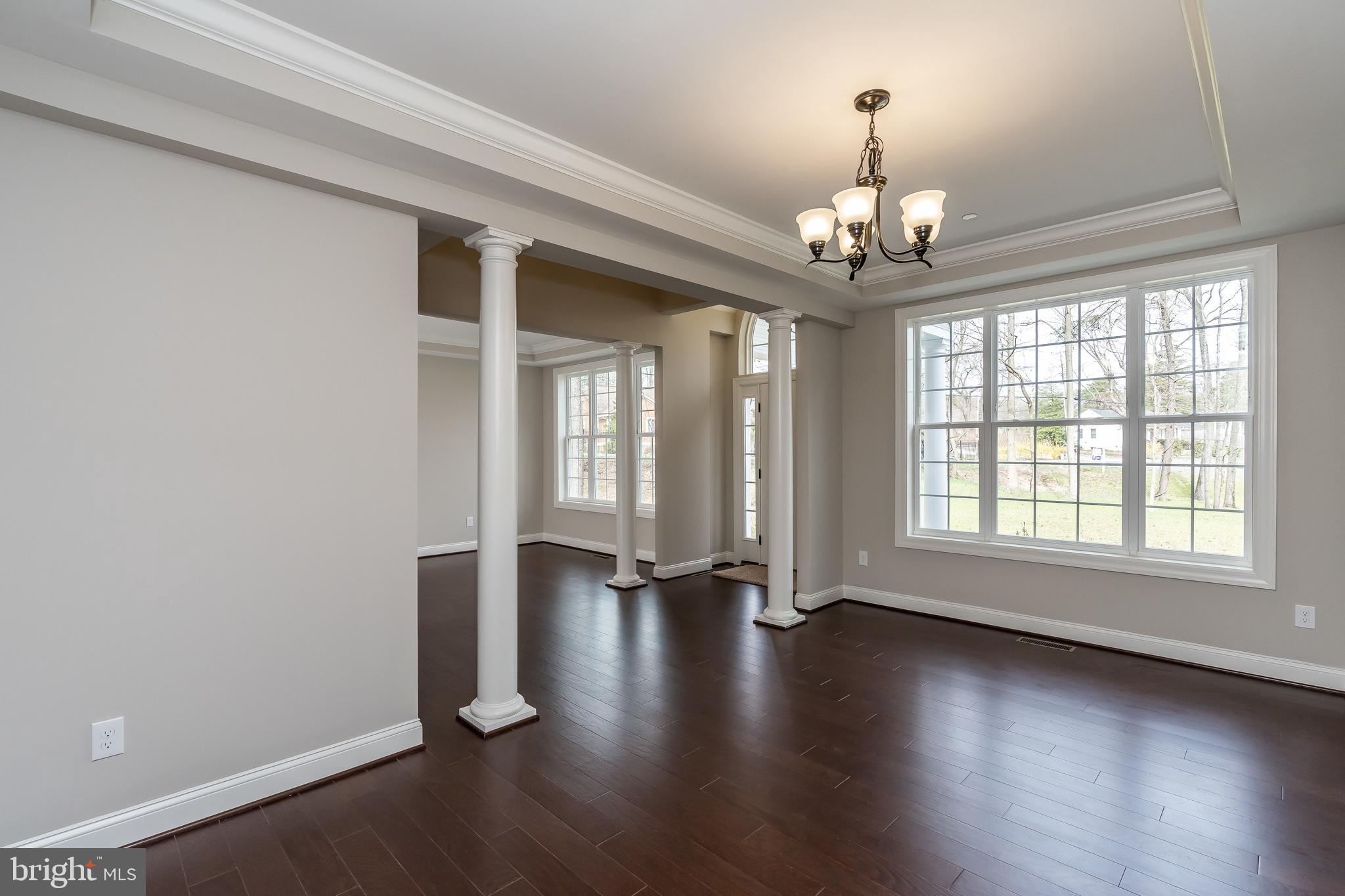 470 Queenstown Road Severn, MD 21144 - Photo 11 of 56 an empty room with wooden floor and windows