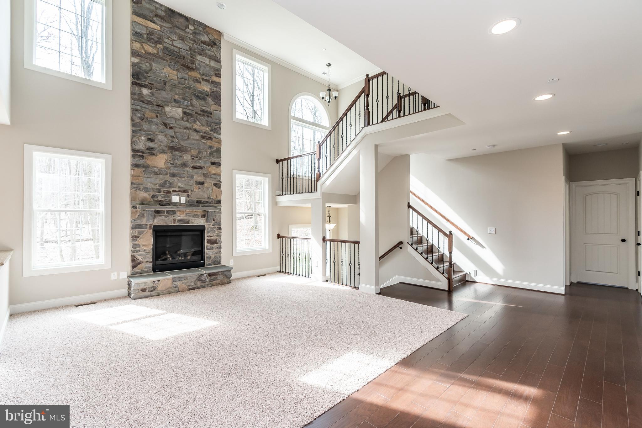 470 Queenstown Road Severn, MD 21144 - Photo 16 of 56 a view of a livingroom with wooden floor staircase and a kitchen