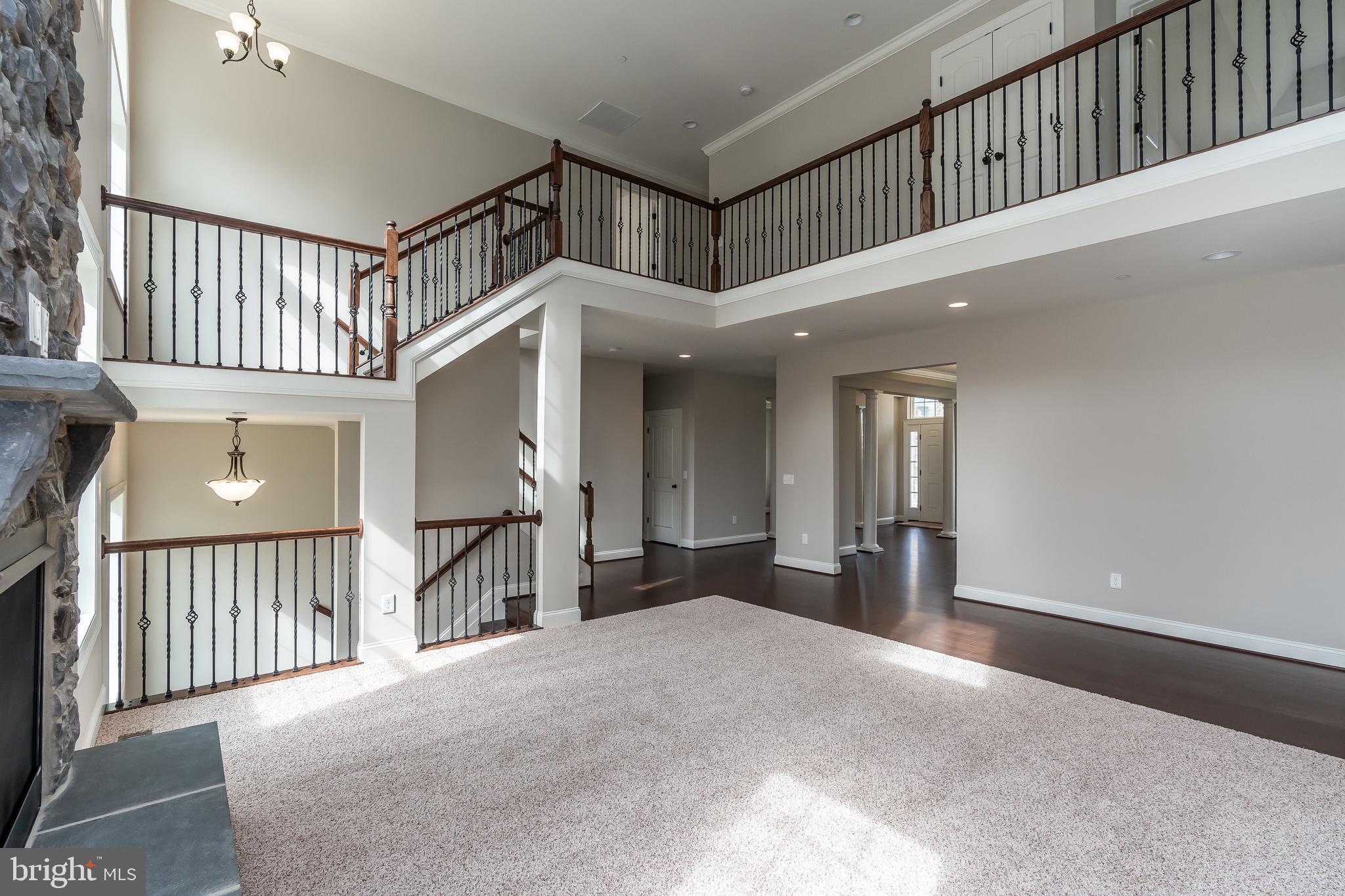 470 Queenstown Road Severn, MD 21144 - Photo 18 of 56 a view of a hallway with a livingroom with furniture and stairs