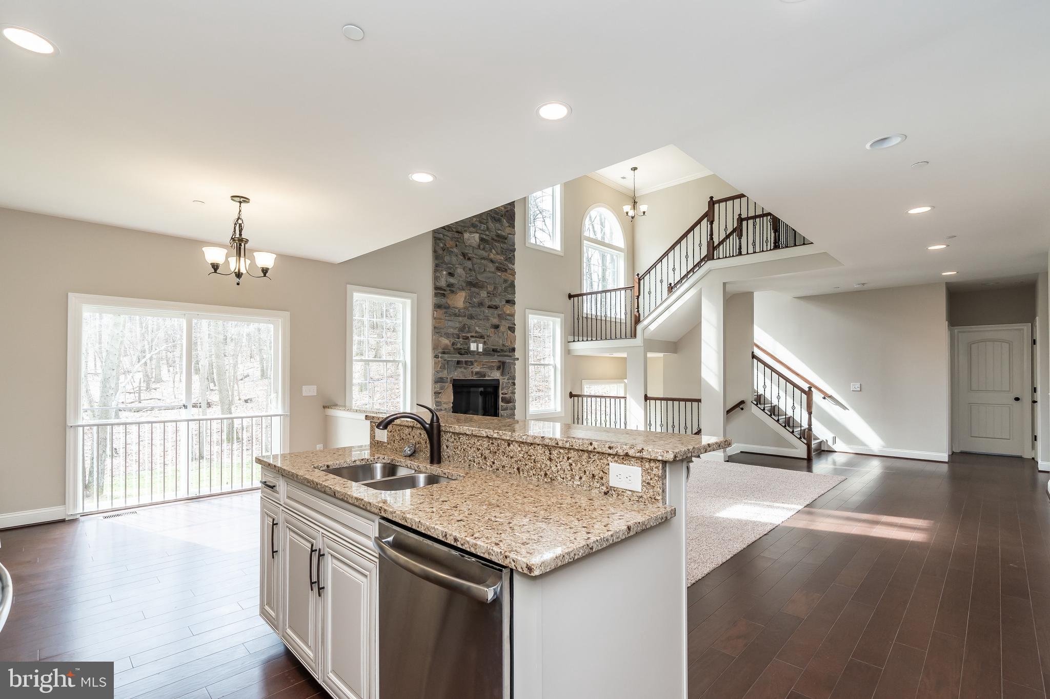 470 Queenstown Road Severn, MD 21144 - Photo 23 of 56 a kitchen with stainless steel appliances granite countertop a sink a stove and a wooden floors