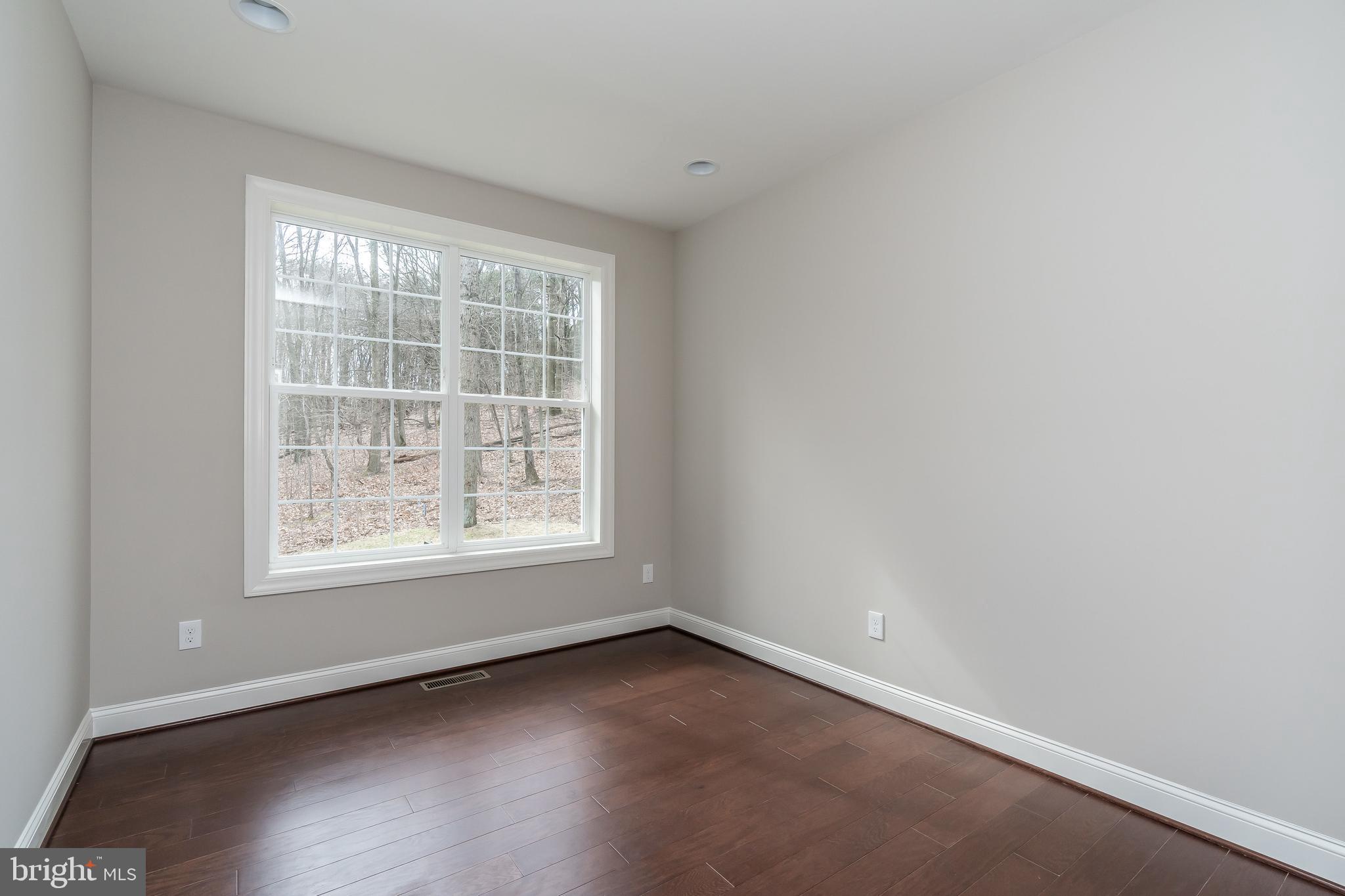 470 Queenstown Road Severn, MD 21144 - Photo 28 of 56 an empty room with wooden floor and windows