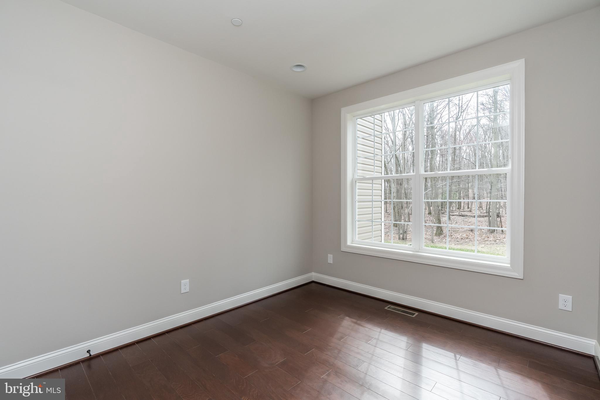 470 Queenstown Road Severn, MD 21144 - Photo 29 of 56 an empty room with wooden floor and windows