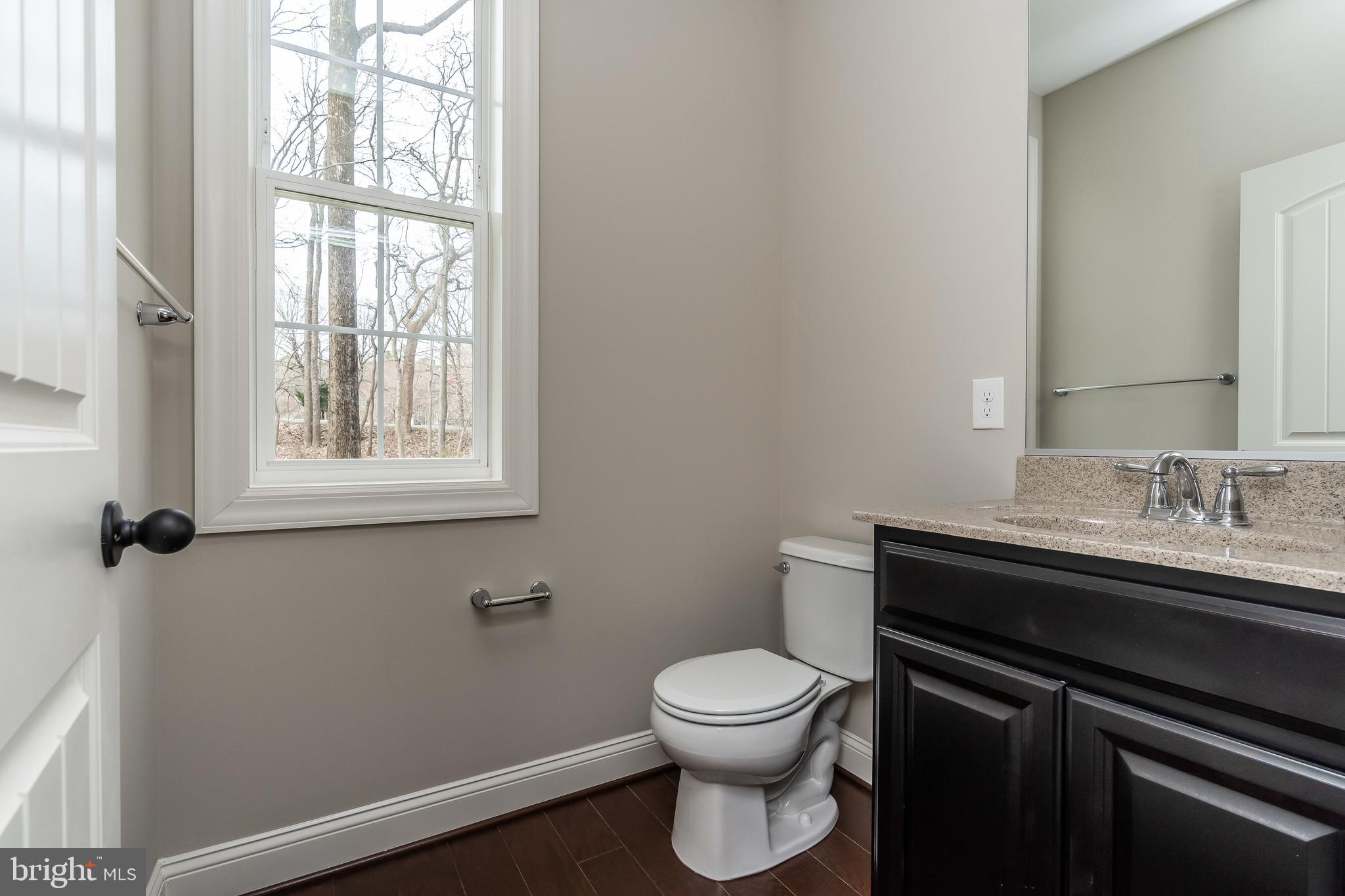 470 Queenstown Road Severn, MD 21144 - Photo 30 of 56 a bathroom with a sink a toilet and a window
