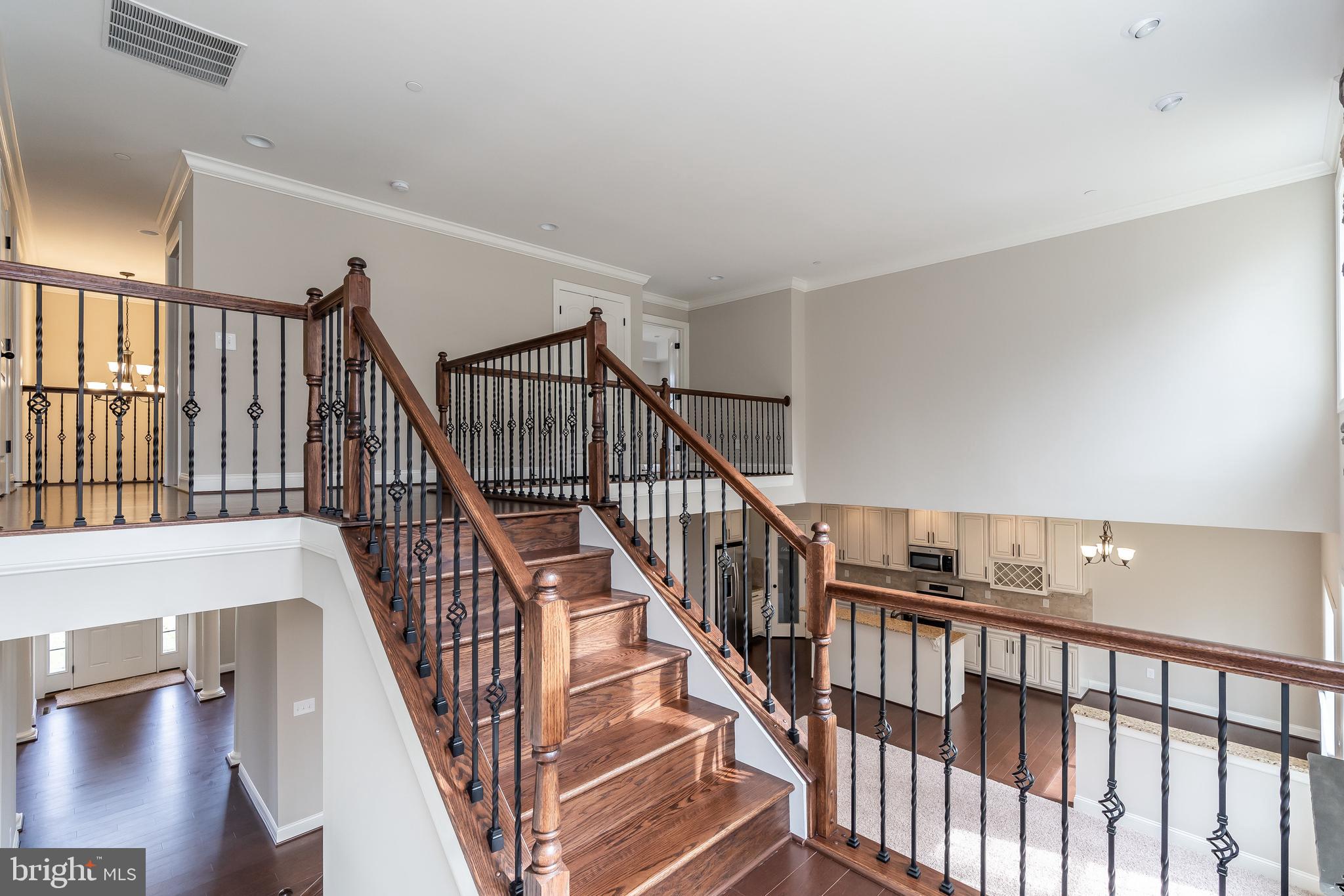 470 Queenstown Road Severn, MD 21144 - Photo 31 of 56 a view of staircase with wooden floor and a floor to ceiling window