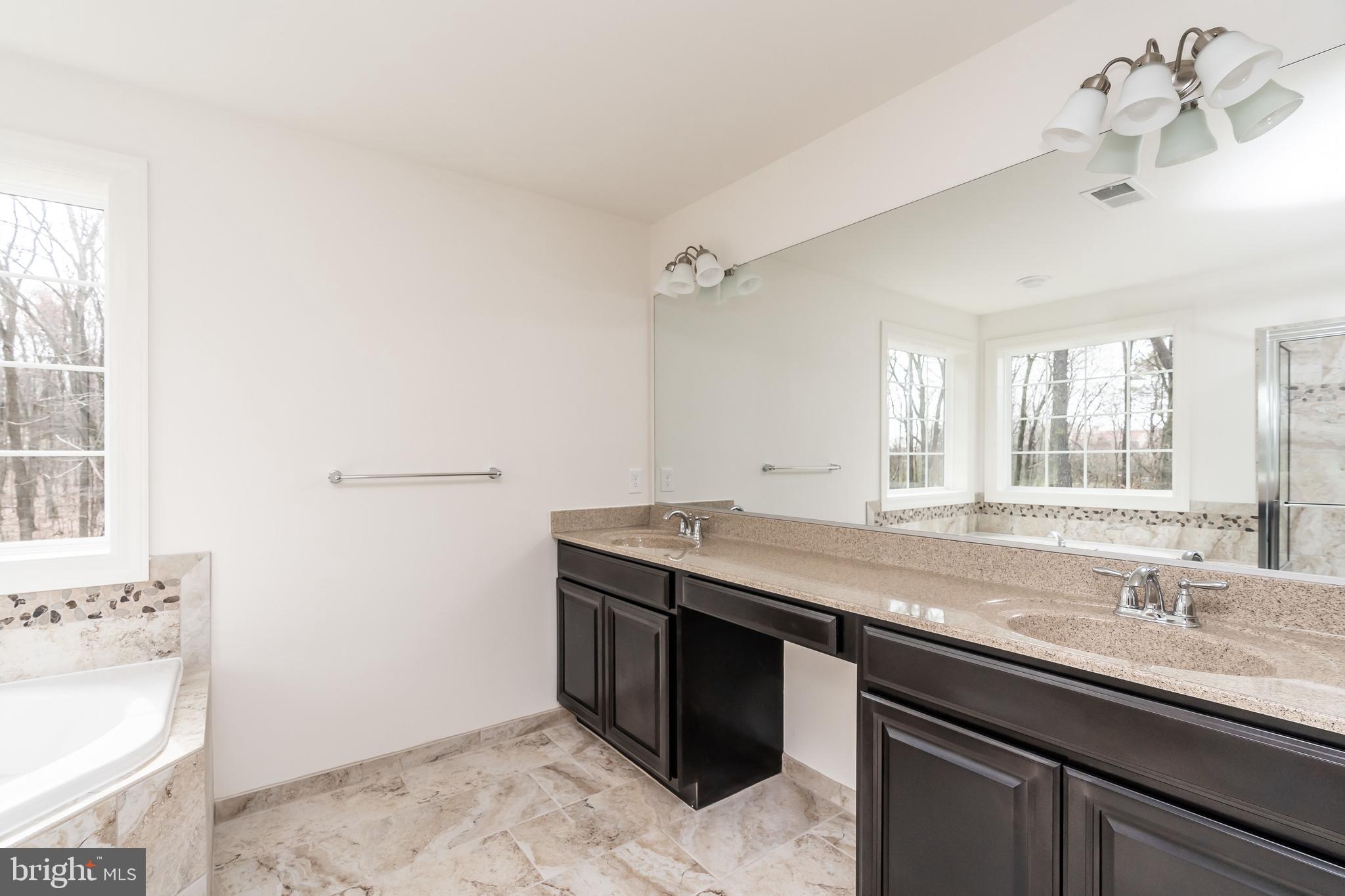 470 Queenstown Road Severn, MD 21144 - Photo 46 of 56 a bath room with a sink and a mirror