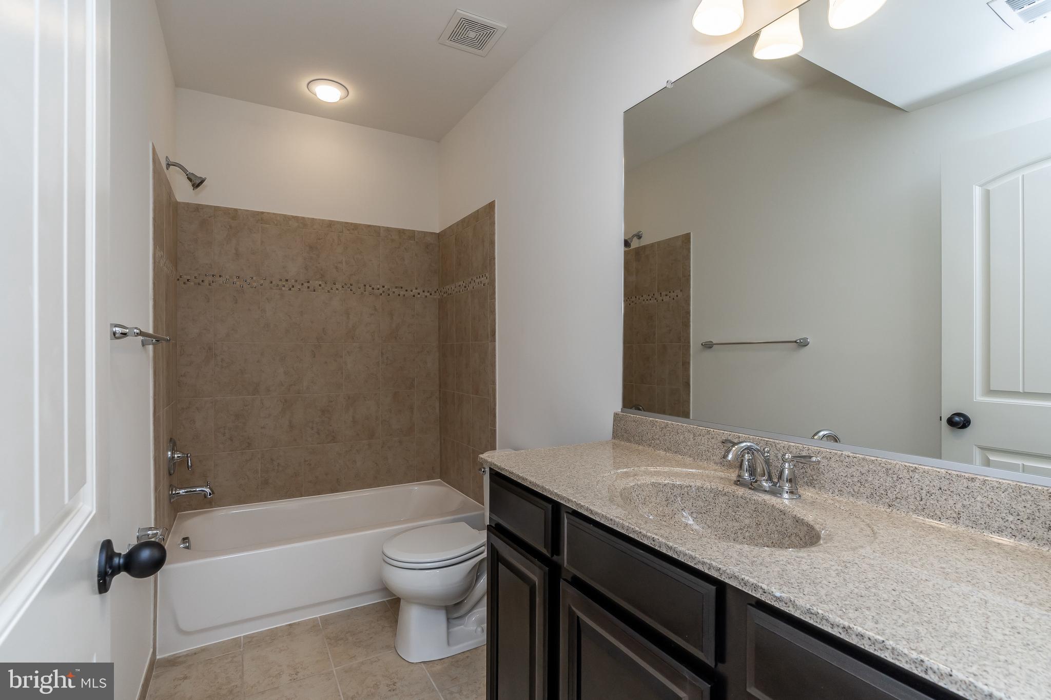 470 Queenstown Road Severn, MD 21144 - Photo 53 of 56 a bathroom with a granite countertop sink toilet and shower