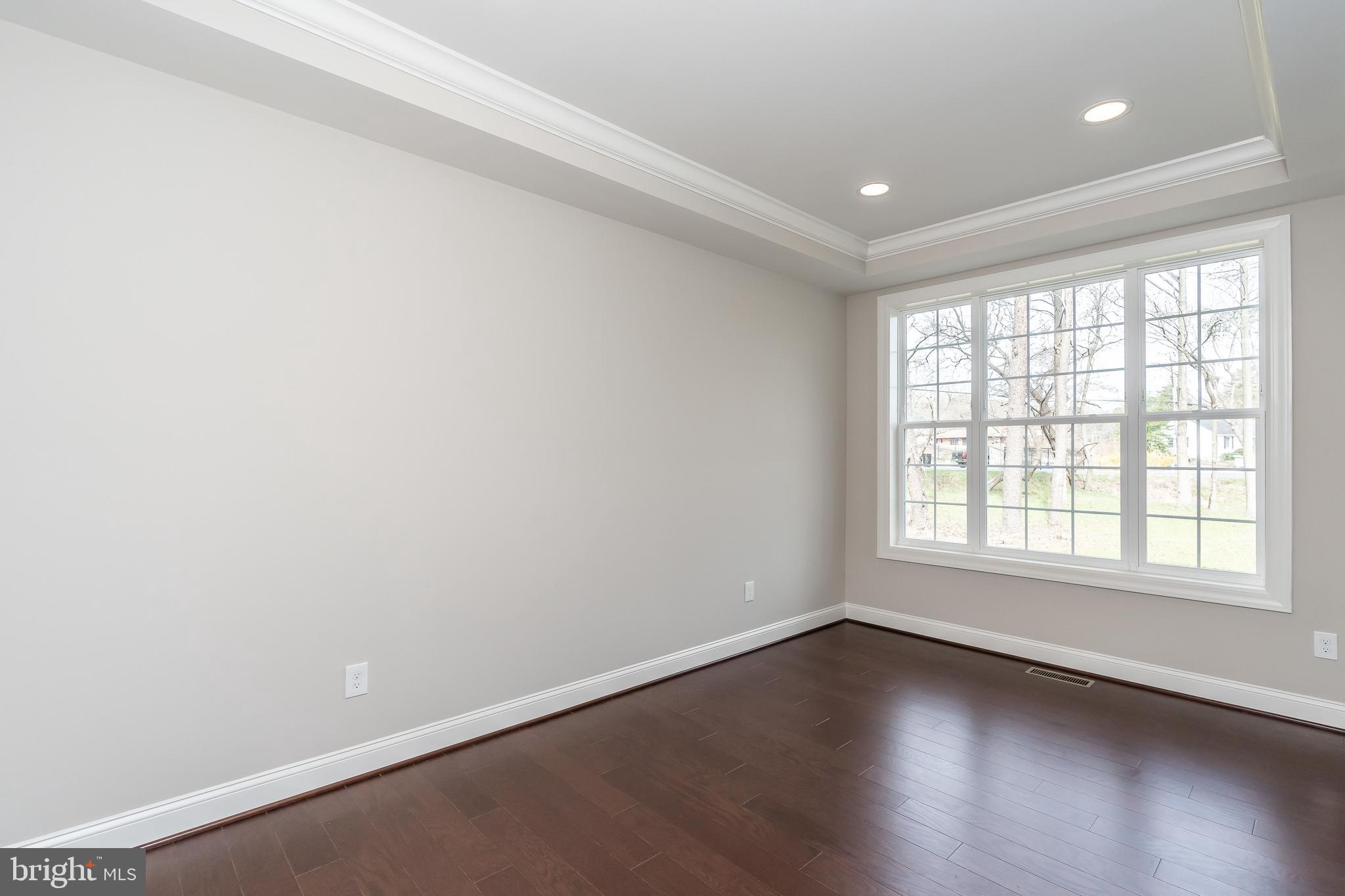 470 Queenstown Road Severn, MD 21144 - Photo 8 of 56 an empty room with wooden floor and windows