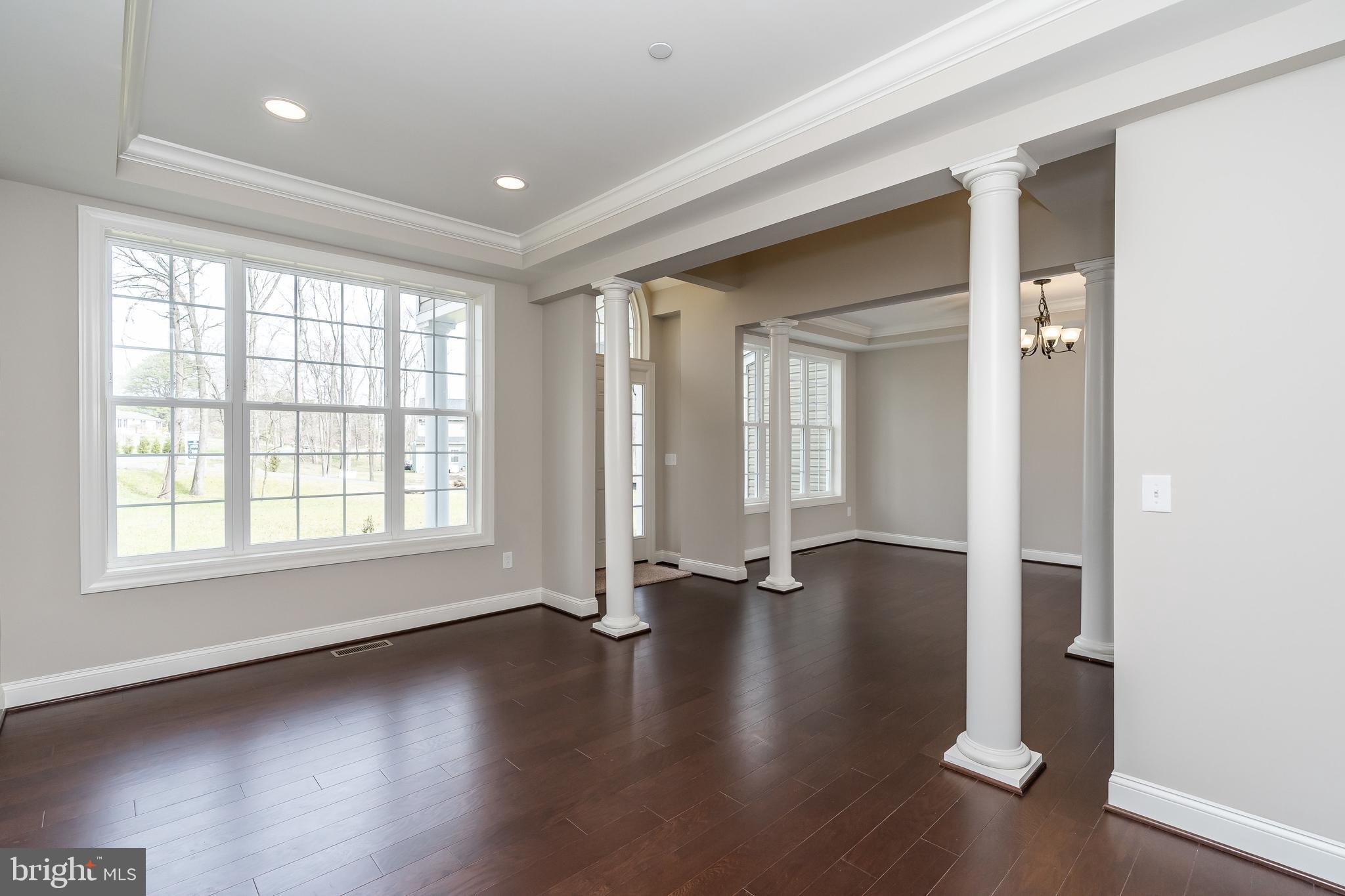 470 Queenstown Road Severn, MD 21144 - Photo 9 of 56 a view of empty room with wooden floor and fan