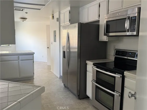 a kitchen with stainless steel appliances and cabinets