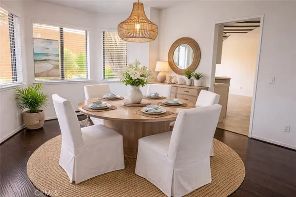a dining room with furniture a potted plant and a chandelier