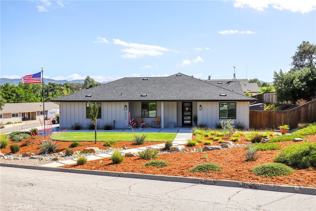8550 El Corte Road Atascadero, CA 93422 - Photo 69 of 72 a front view of house with yard outdoor seating and covered with palm trees
