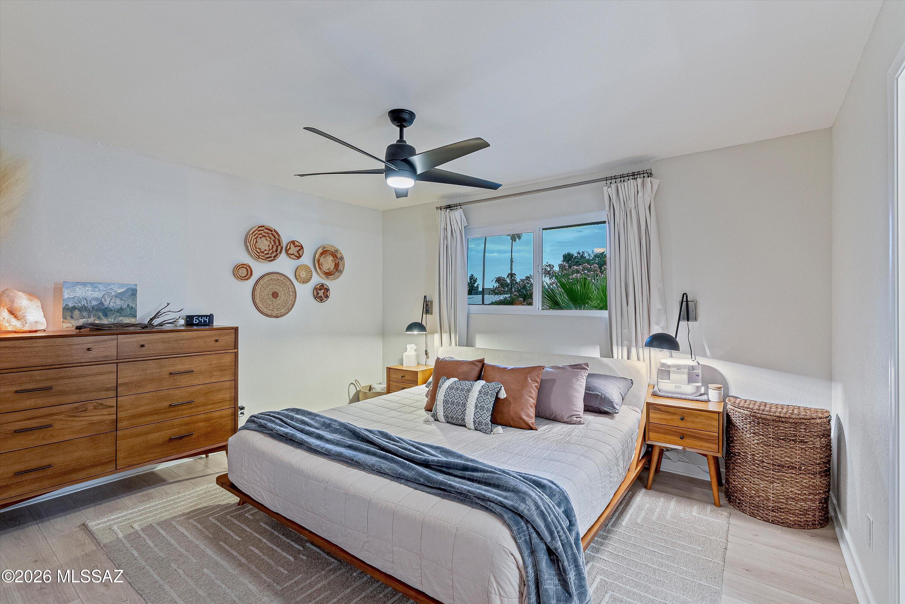 3949 West Mars Street Tucson, AZ 85741 - Photo 15 of 27 a bedroom with a bed and a chandelier
